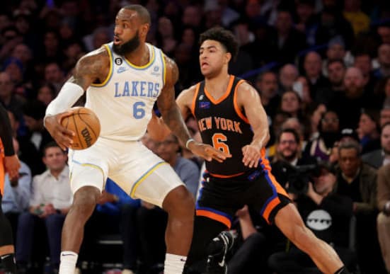James (in white) is guarded by Quentin Grimes during Los Angeles' 2023 visit to Madison Square Garden